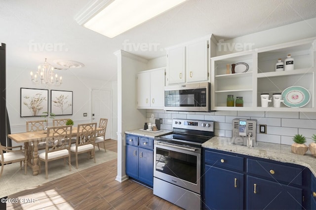 kitchen featuring open shelves, blue cabinetry, stainless steel appliances, and backsplash