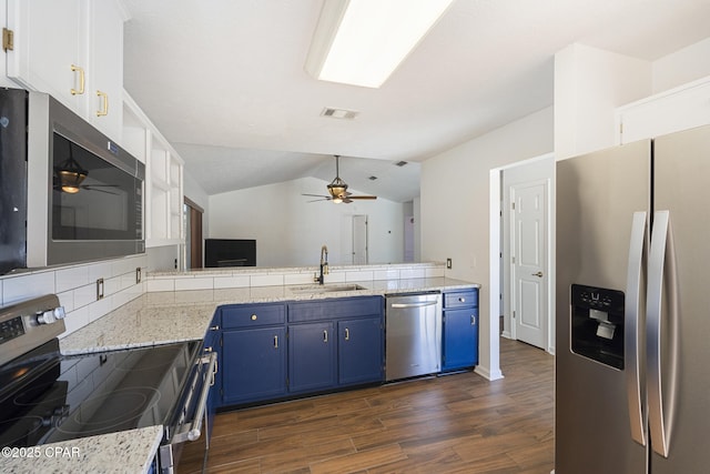 kitchen featuring blue cabinets, a sink, a ceiling fan, vaulted ceiling, and appliances with stainless steel finishes