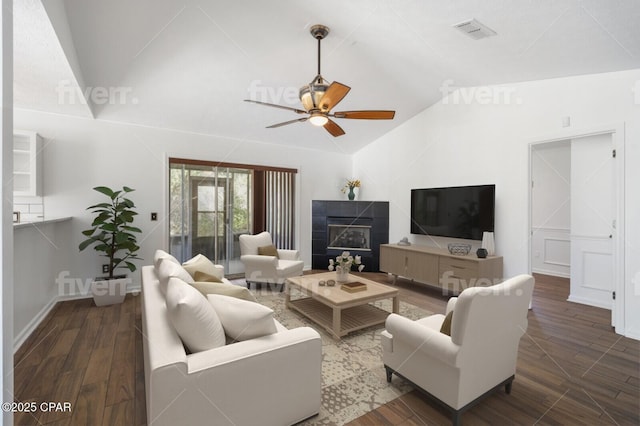 living room with visible vents, a tile fireplace, ceiling fan, wood finished floors, and vaulted ceiling