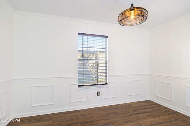 spare room with a wainscoted wall, dark wood-type flooring, a decorative wall, and crown molding