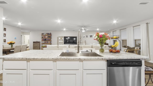 kitchen featuring visible vents, white cabinets, open floor plan, light countertops, and stainless steel dishwasher