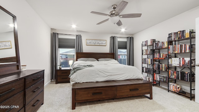 bedroom featuring light carpet and a ceiling fan