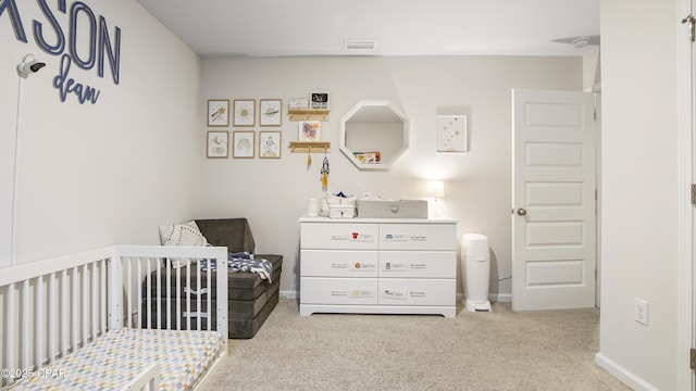 bedroom with a nursery area, baseboards, visible vents, and light colored carpet