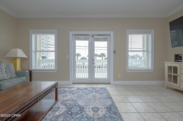 entryway with light tile patterned floors, french doors, baseboards, and crown molding