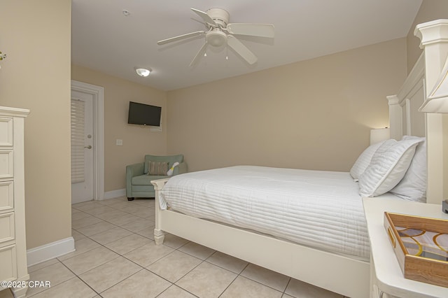 bedroom featuring ceiling fan, baseboards, and light tile patterned floors