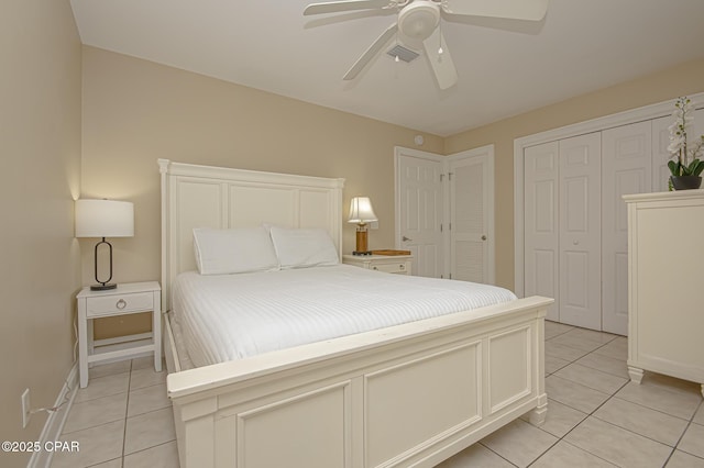 bedroom with light tile patterned floors, ceiling fan, visible vents, and baseboards