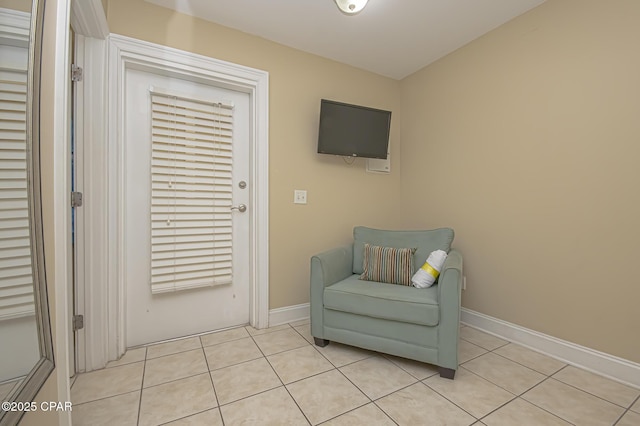 sitting room with light tile patterned flooring and baseboards