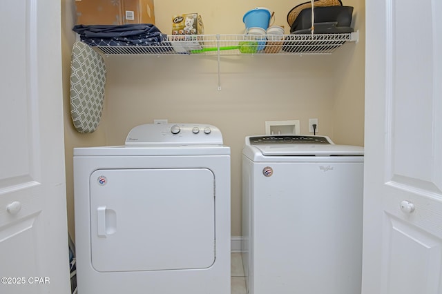 clothes washing area featuring laundry area and washer and clothes dryer