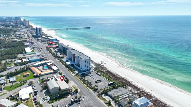 birds eye view of property with a water view and a beach view