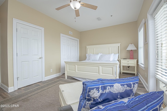 bedroom featuring baseboards, visible vents, and a closet