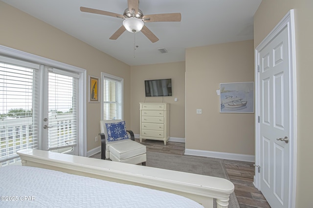 bedroom with baseboards, visible vents, a ceiling fan, wood finished floors, and access to exterior