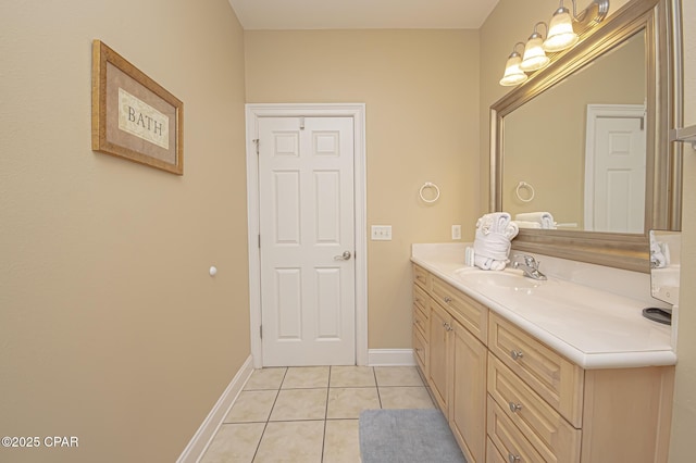 bathroom with vanity, baseboards, and tile patterned floors