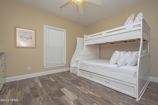 unfurnished bedroom featuring dark wood finished floors, a ceiling fan, and baseboards