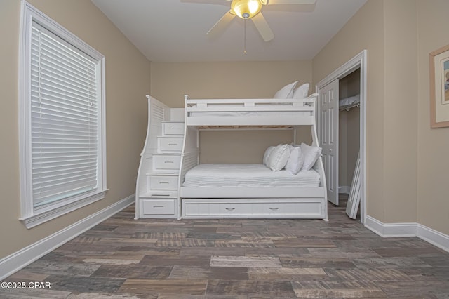 unfurnished bedroom with a ceiling fan, baseboards, and wood finished floors