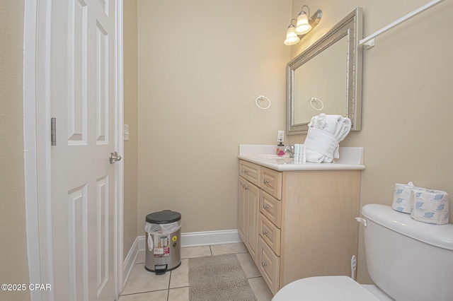 bathroom with baseboards, vanity, toilet, and tile patterned floors