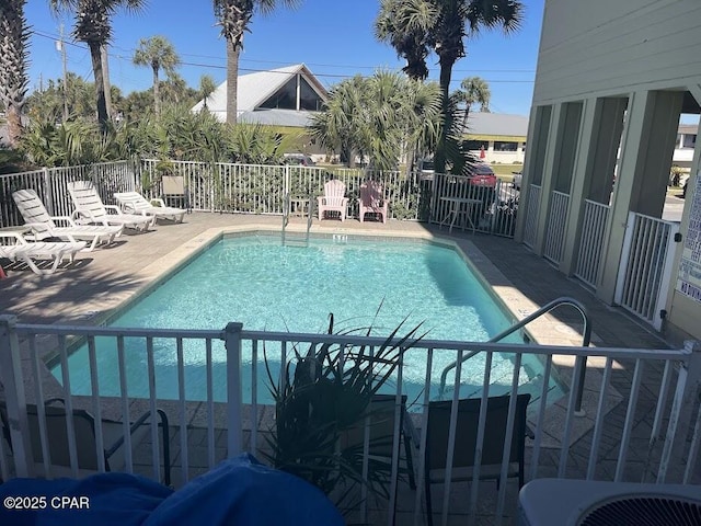 community pool featuring a patio area and central AC