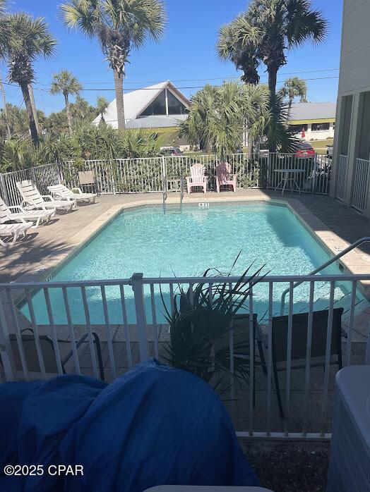 pool with fence and a patio