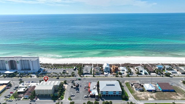 bird's eye view with a water view and a beach view