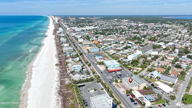 bird's eye view with a water view and a beach view