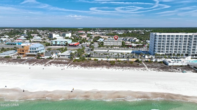 bird's eye view featuring a water view and a beach view