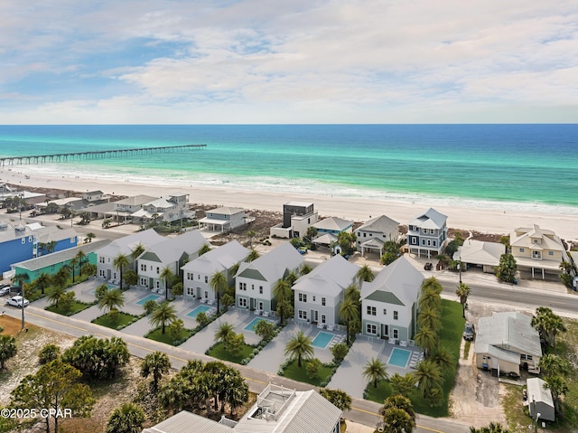 bird's eye view with a water view, a residential view, and a view of the beach