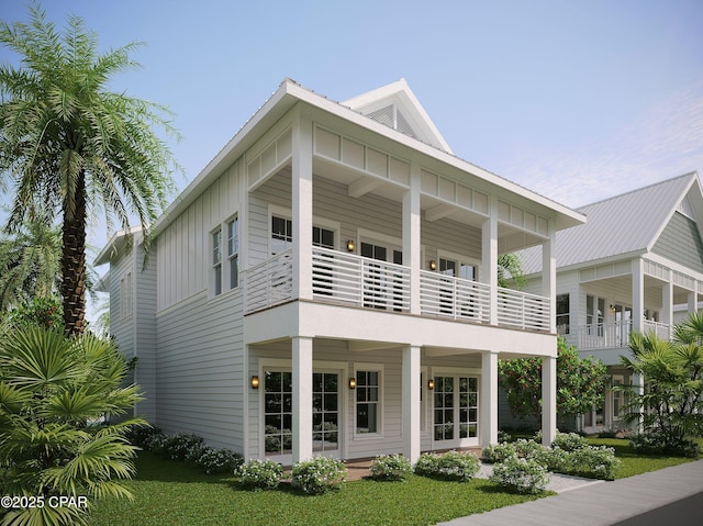 rear view of property featuring a balcony and board and batten siding