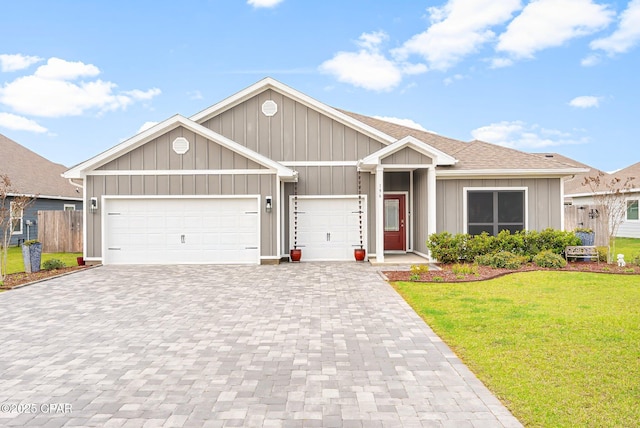 ranch-style house featuring a garage, board and batten siding, a front lawn, and decorative driveway