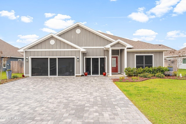 196 Martingale Loop, Lynn Haven, FL 32444 - view of front of home with decorative driveway, a front yard, a garage, board and batten siding, and a shingled roof