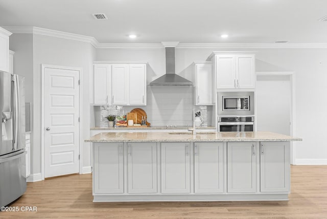 196 Martingale Loop, Lynn Haven, FL 32444 - kitchen featuring stainless steel appliances, wall chimney exhaust hood, a sink, white cabinetry, and decorative backsplash
