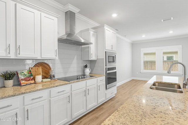 196 Martingale Loop, Lynn Haven, FL 32444 - kitchen featuring appliances with stainless steel finishes, a sink, wall chimney range hood, light wood finished floors, and crown molding