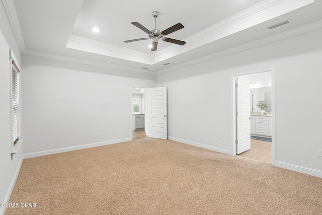 196 Martingale Loop, Lynn Haven, FL 32444 - unfurnished bedroom featuring light colored carpet, ornamental molding, baseboards, ensuite bath, and a tray ceiling