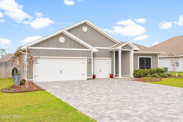 view of front facade featuring a garage, decorative driveway, board and batten siding, and a front yard