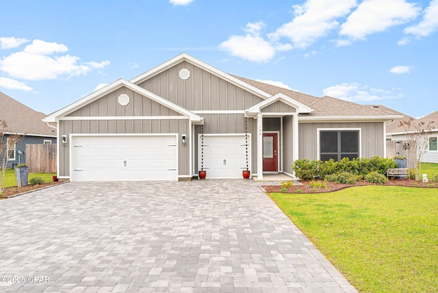 196 Martingale Loop, Lynn Haven, FL 32444 - view of front facade featuring decorative driveway, an attached garage, board and batten siding, and roof with shingles