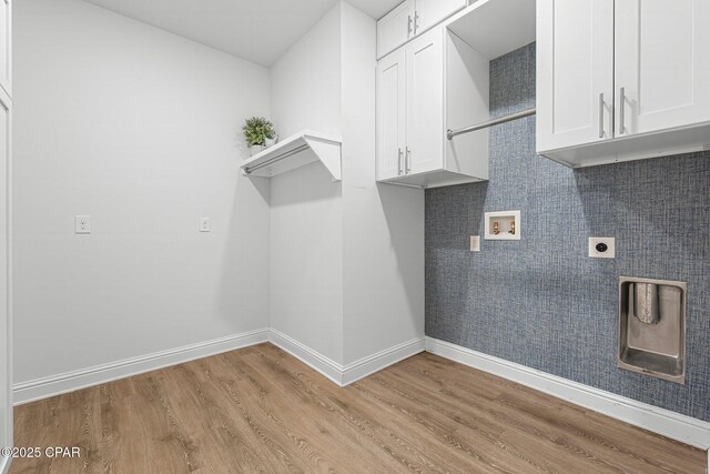196 Martingale Loop, Lynn Haven, FL 32444 - washroom featuring washer hookup, electric dryer hookup, light wood-type flooring, and cabinet space