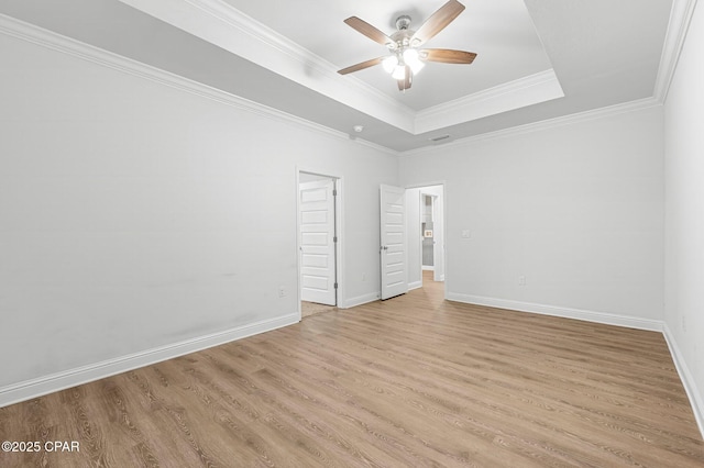 196 Martingale Loop, Lynn Haven, FL 32444 - spare room featuring a raised ceiling, ceiling fan, light wood-type flooring, baseboards, and ornamental molding