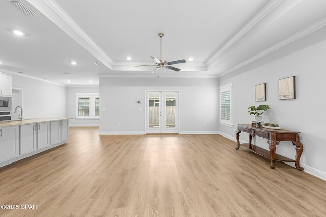 196 Martingale Loop, Lynn Haven, FL 32444 - unfurnished living room with a ceiling fan, ornamental molding, light wood-style floors, a raised ceiling, and recessed lighting