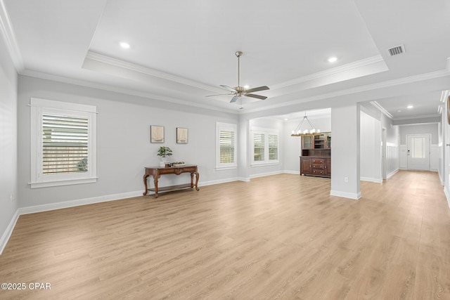 196 Martingale Loop, Lynn Haven, FL 32444 - unfurnished living room with a ceiling fan, light wood finished floors, a tray ceiling, baseboards, and crown molding