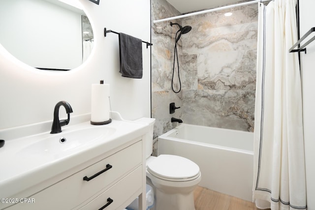 full bathroom with toilet, shower / tub combo, wood finished floors, and vanity