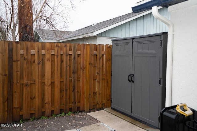 view of outbuilding with fence