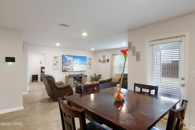 dining room featuring visible vents, baseboards, recessed lighting, and light wood finished floors