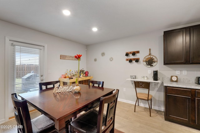 dining space with light wood-style flooring, recessed lighting, and baseboards