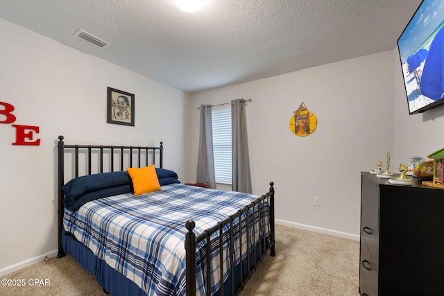 bedroom with visible vents, a textured ceiling, baseboards, and carpet floors