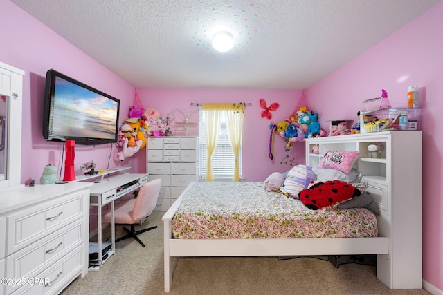 bedroom with light colored carpet and a textured ceiling