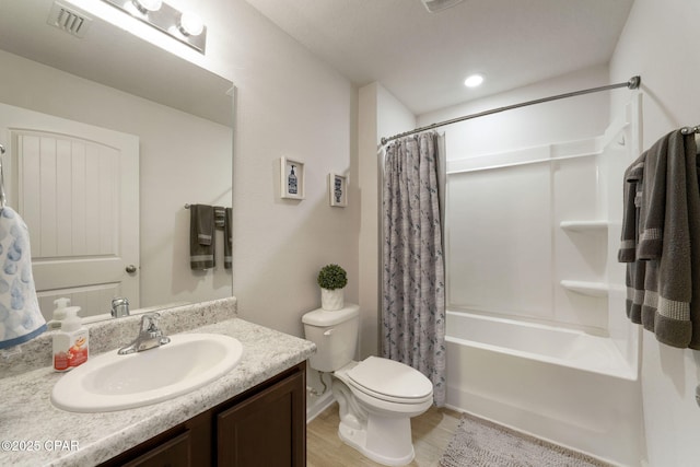 full bath with vanity, visible vents, toilet, shower / bath combo, and wood finished floors