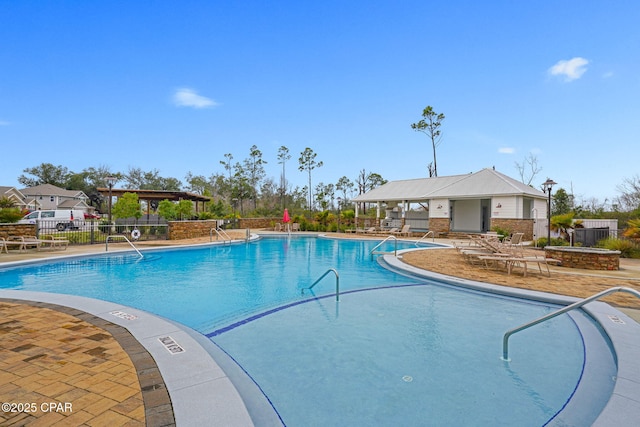 community pool featuring a patio area and fence