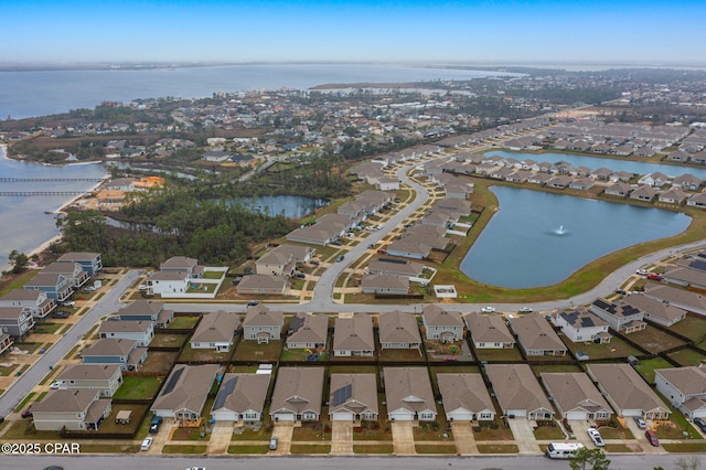 drone / aerial view featuring a residential view and a water view
