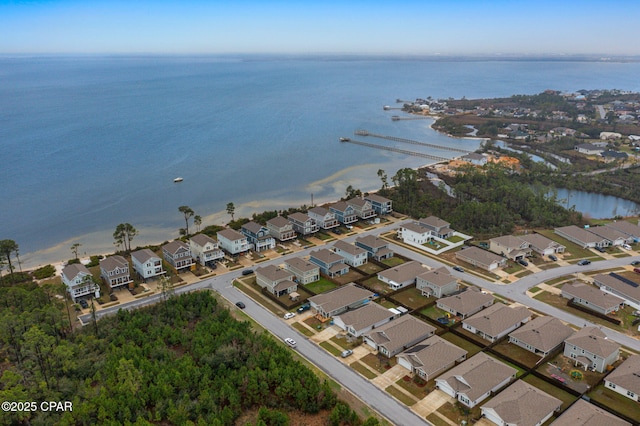 drone / aerial view featuring a water view and a residential view