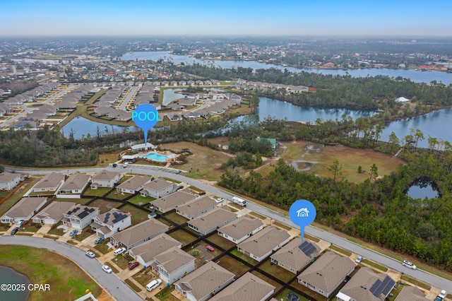 drone / aerial view featuring a water view and a residential view