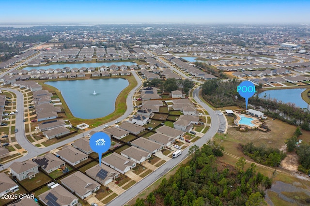 birds eye view of property with a water view and a residential view