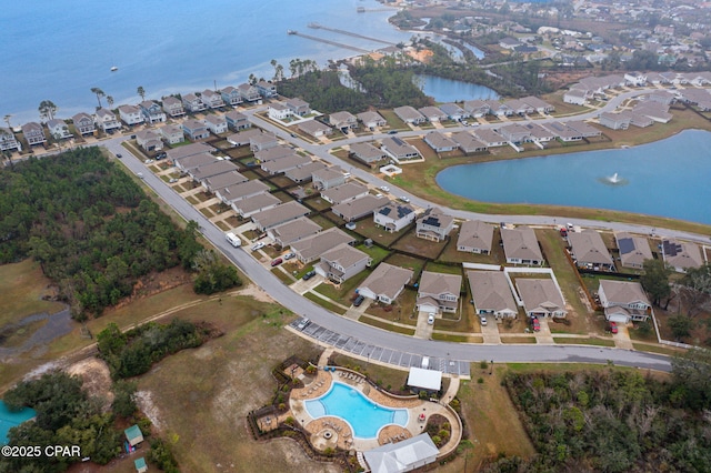 drone / aerial view featuring a water view and a residential view